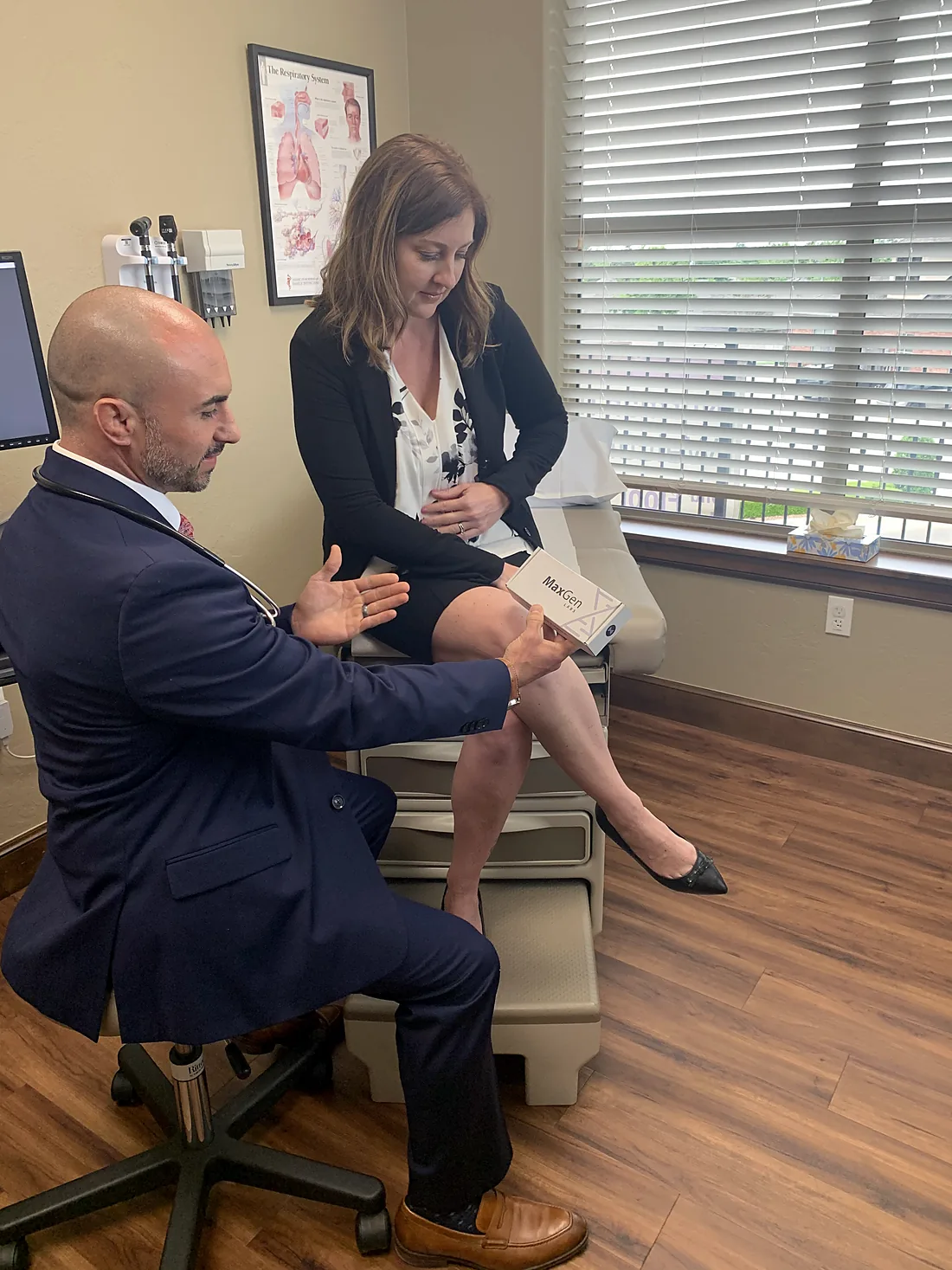 Dr. Cas talking through results with a patient in the exam room